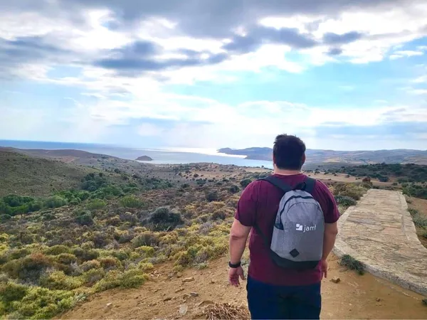 Person looking over mountain view with Jamf backpack