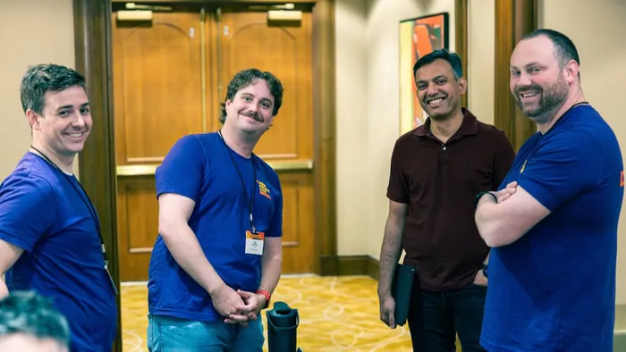 A group of four smiling Jamf Nation Live attendees