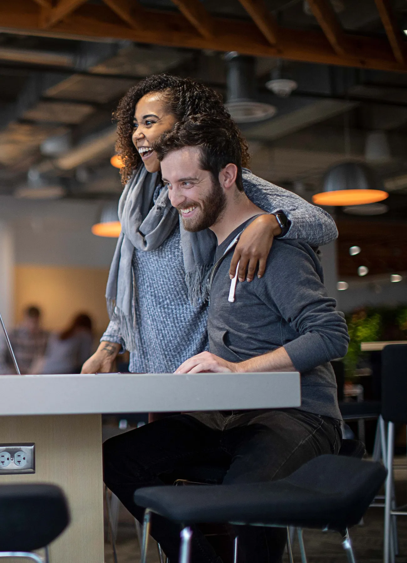 Co-workers laugh together in a common area at Jamf Minneapolis headquarters.