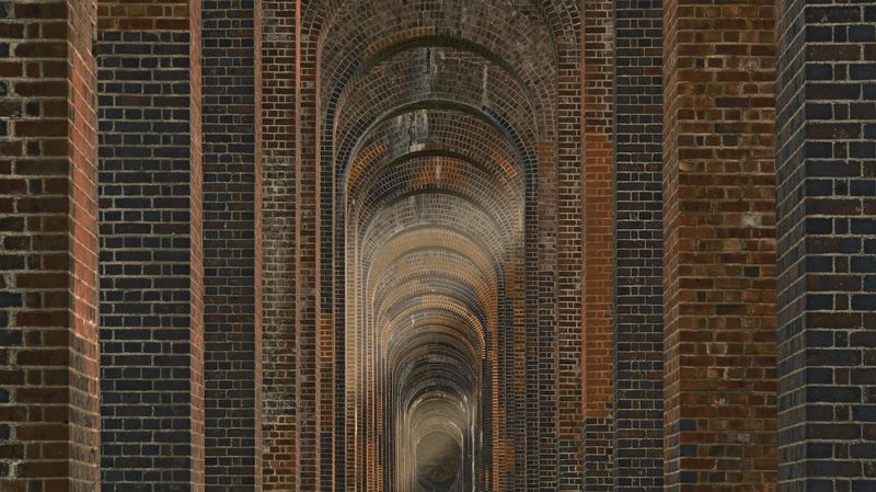 A series of tall brick archways forming the supports for a viaduct