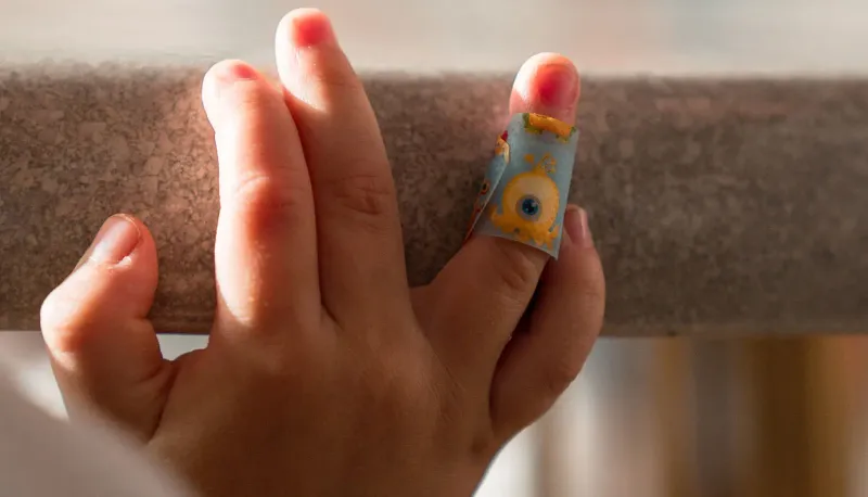 Child's hand with a bandage on their finger