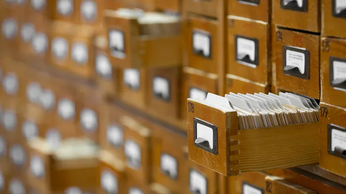 Card catalog open with cards organized when looking for specific books.