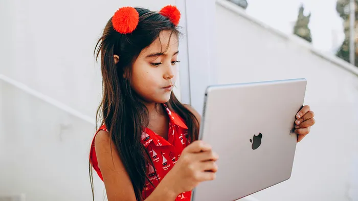 Student reading a book on an iPad managed by Jamf School.