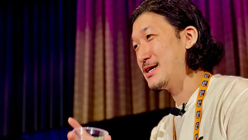 Takumi Nakanishi: a person with dark hair against a JNUC-branded background.
