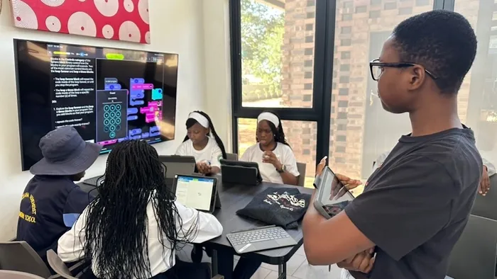 Students using iPads managed by Jamf and their teacher