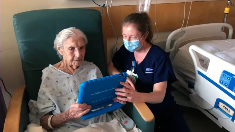 Patient and clinician look at an iPad together.