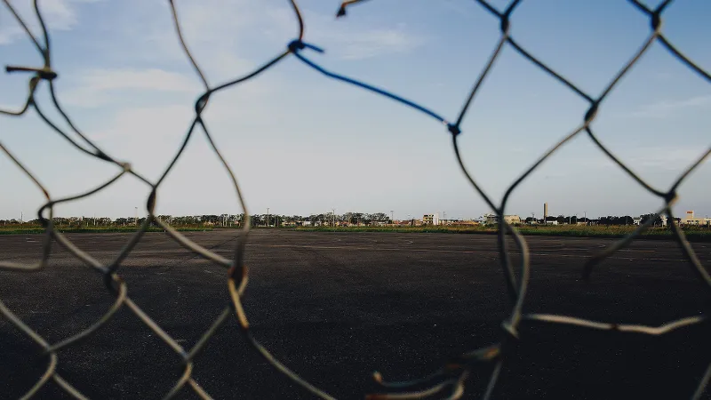 Missing links in a chain-link fence illustrate the holes in Enterprise security without AI governance.