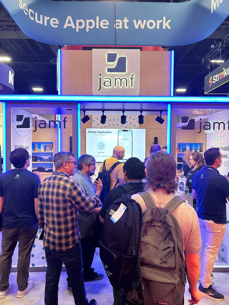 A crowd visits the Jamf booth during a Black Hat presentation.