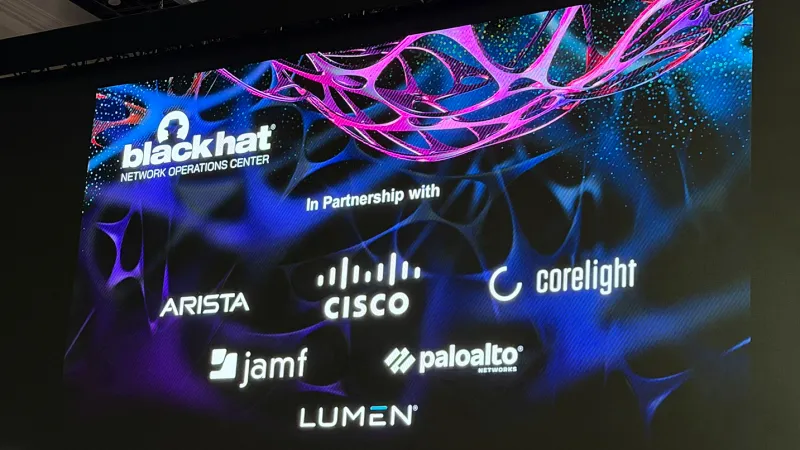 Image on a large screen at Black Hat's 2026 conference: Black hat(r)/Network Operations Center/In Partnership with/ARISTA CISCO core light Jamf paloalto (r) LUMEN