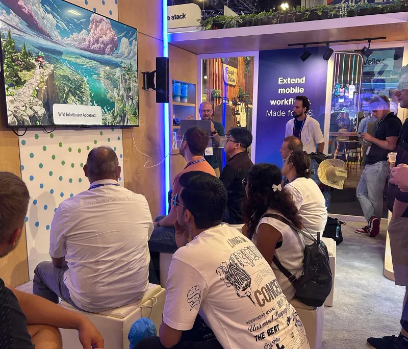 A crowd of Apple admins at the Jamf booth learn about Mac malware and threat hunting at Black Hat 2026.
