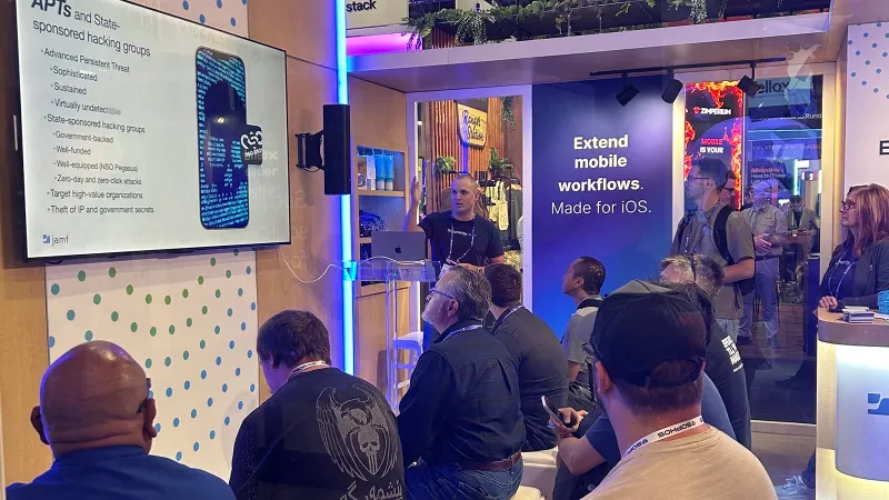 A crowd sits in Jamf's booth at Black Hat 2026 to learn more about mobile security issues.