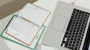 An illustration of an office calendar lying open next to a MacBook