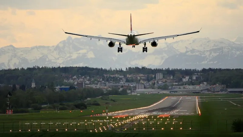 Airplane where employees are using Jamf on their Apple devices landing in mountainous scenery