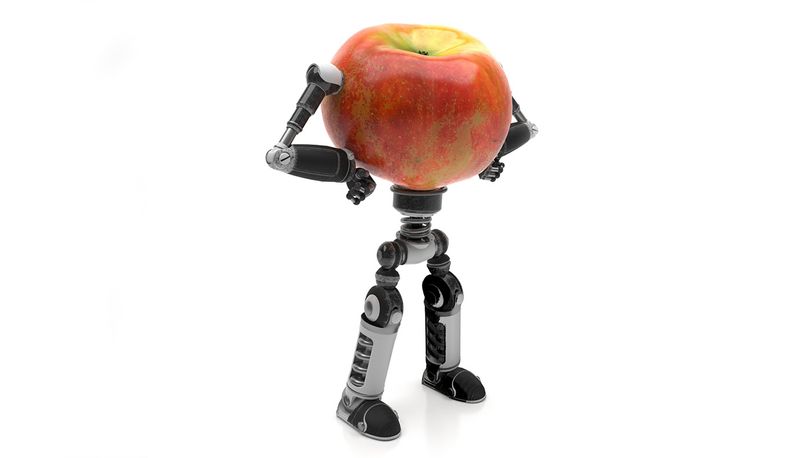 Red apple with robot arms and legs posing contemplatively.