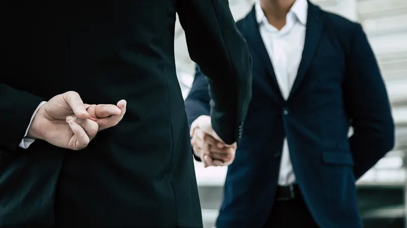 Man's fingers crossed behind his back as he shakes on a deal: Chrome forced updates can hide malicious actors