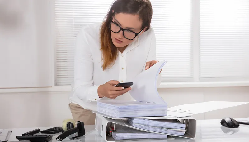 Person using an iPhone to capture sensitive data using the camera.