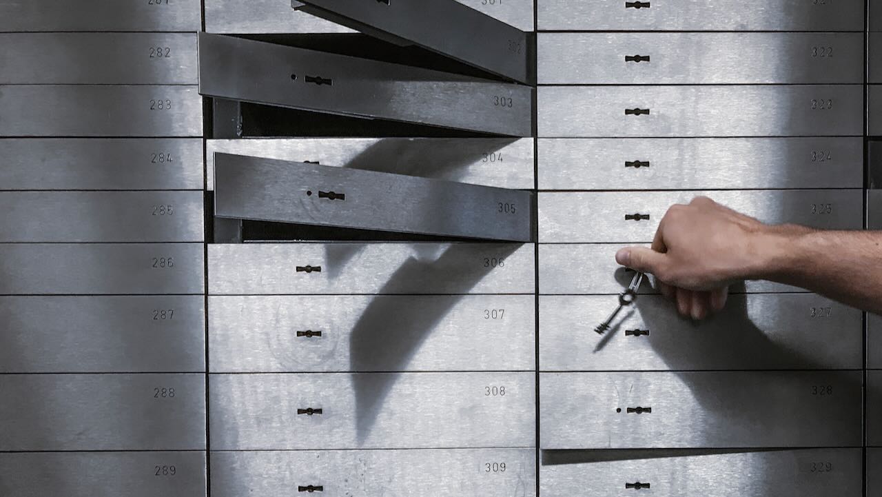 Image of person opening safe deposit boxes