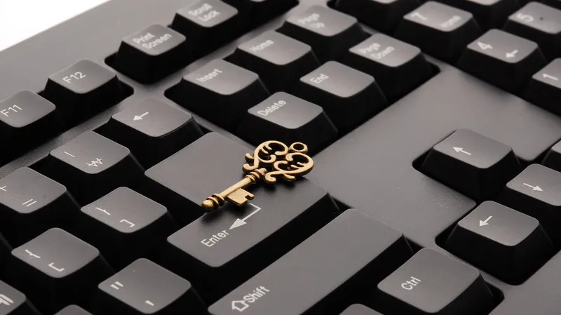 computer keyboard with metal key resting on top.