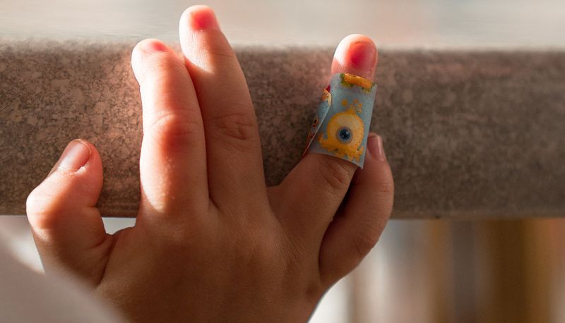 Child's hand with a bandage on their finger