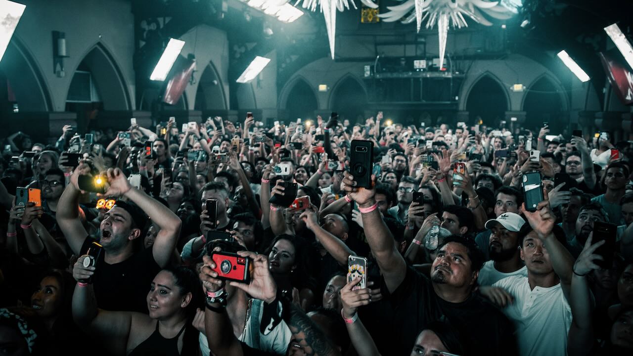 Crowd holding up a variety of smartphones