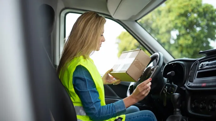 Driver in a reflective vest using a mobile device running LifeSaver Mobile and Jamf