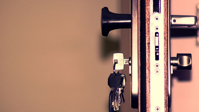 Keys in a well-locked door seen from the side