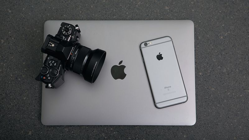 An iPhone, MacBook, and camera.