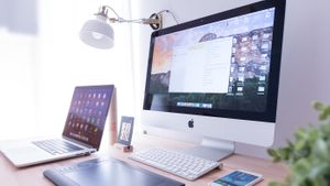Mac computer, iPad and iPhone on desk.