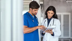 Doctor and nurse review iPad managed by Jamf.