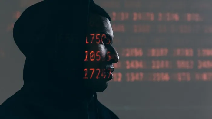 Hacker overlaid with computer code