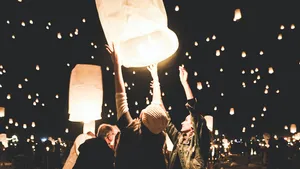 Grouping of Jamf admins releasing light-filled kites celebrating the release of Jamf Pro 11.15