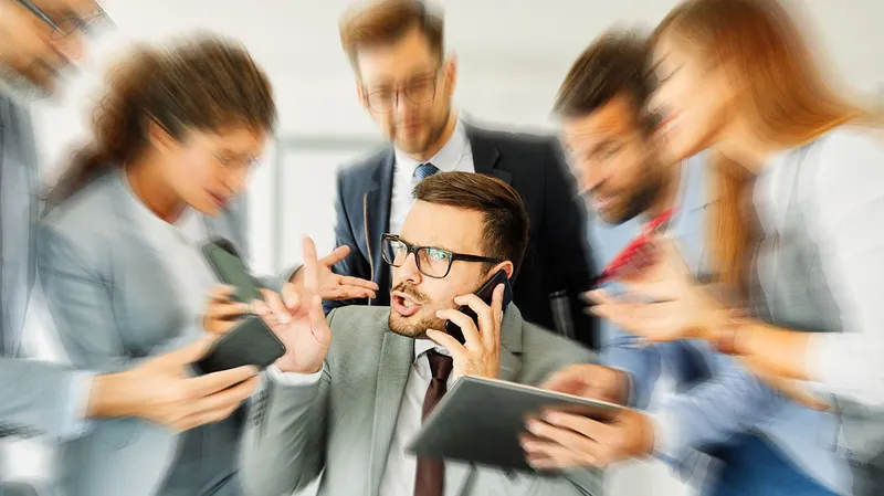 Person on cell phone being inundated by a crowd of people demanding attention for their devices.