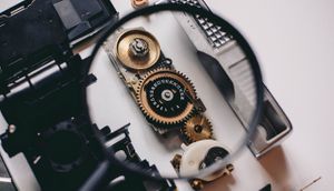 Magnifying glass zooms in to get a closer look at internal moving parts of a clock
