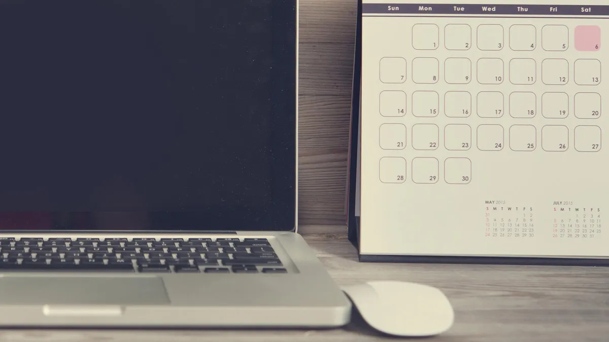 MacBook next to a calendar