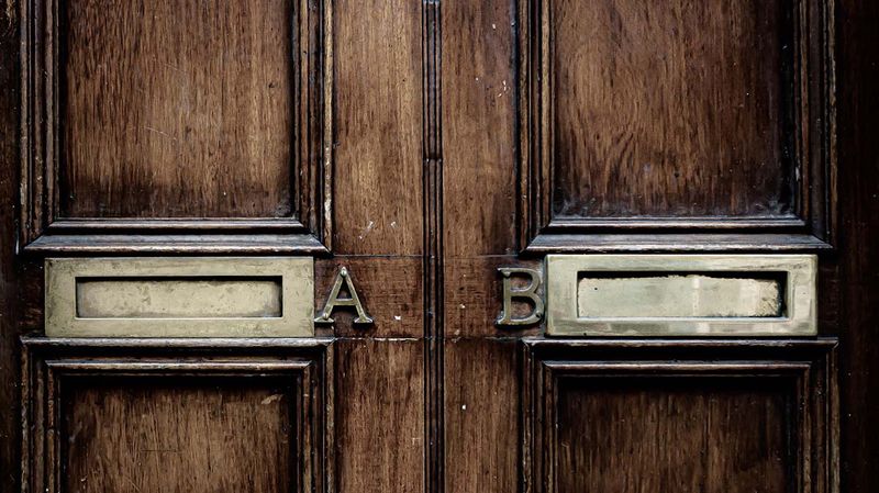 Large wooden doors side-by-side with letters A and B on them.