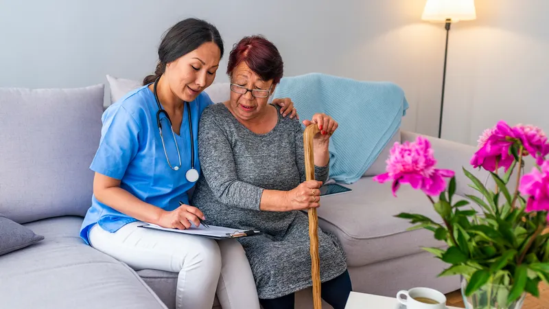A nurse tends to a patient at home
