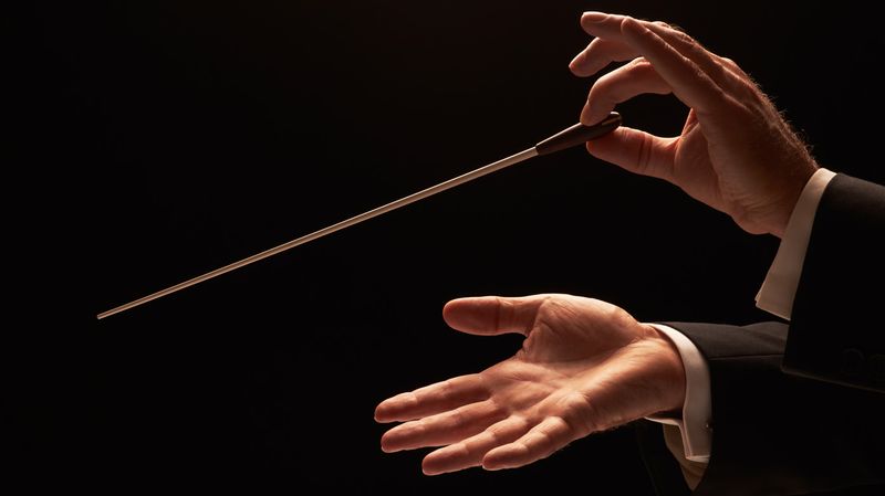 Orchestra conductor's hands demonstrate Security Orchestration with Jamf Pro and Jamf Protect