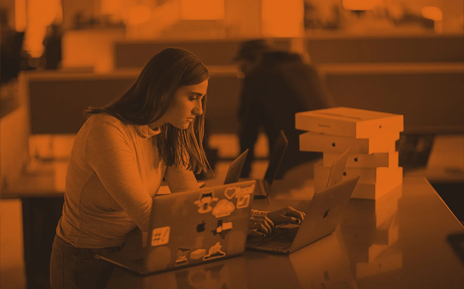 Woman working on Apple devices