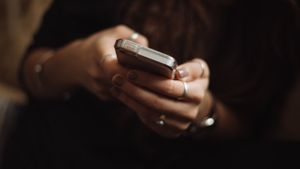 A woman's hands holding a smartphone
